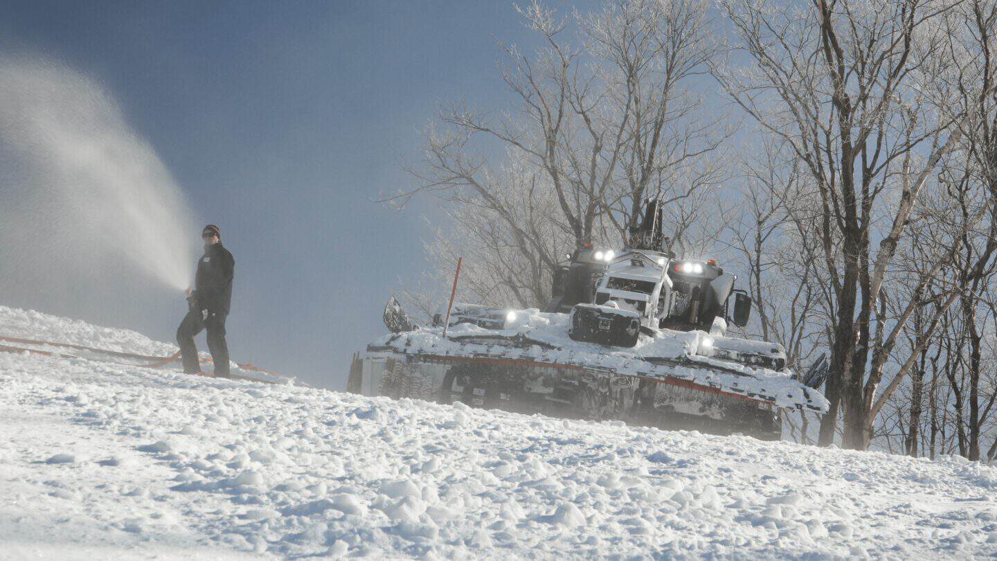 Snowbound Coupe du Monde Tremblant event with a water spray and snow-covered tank.