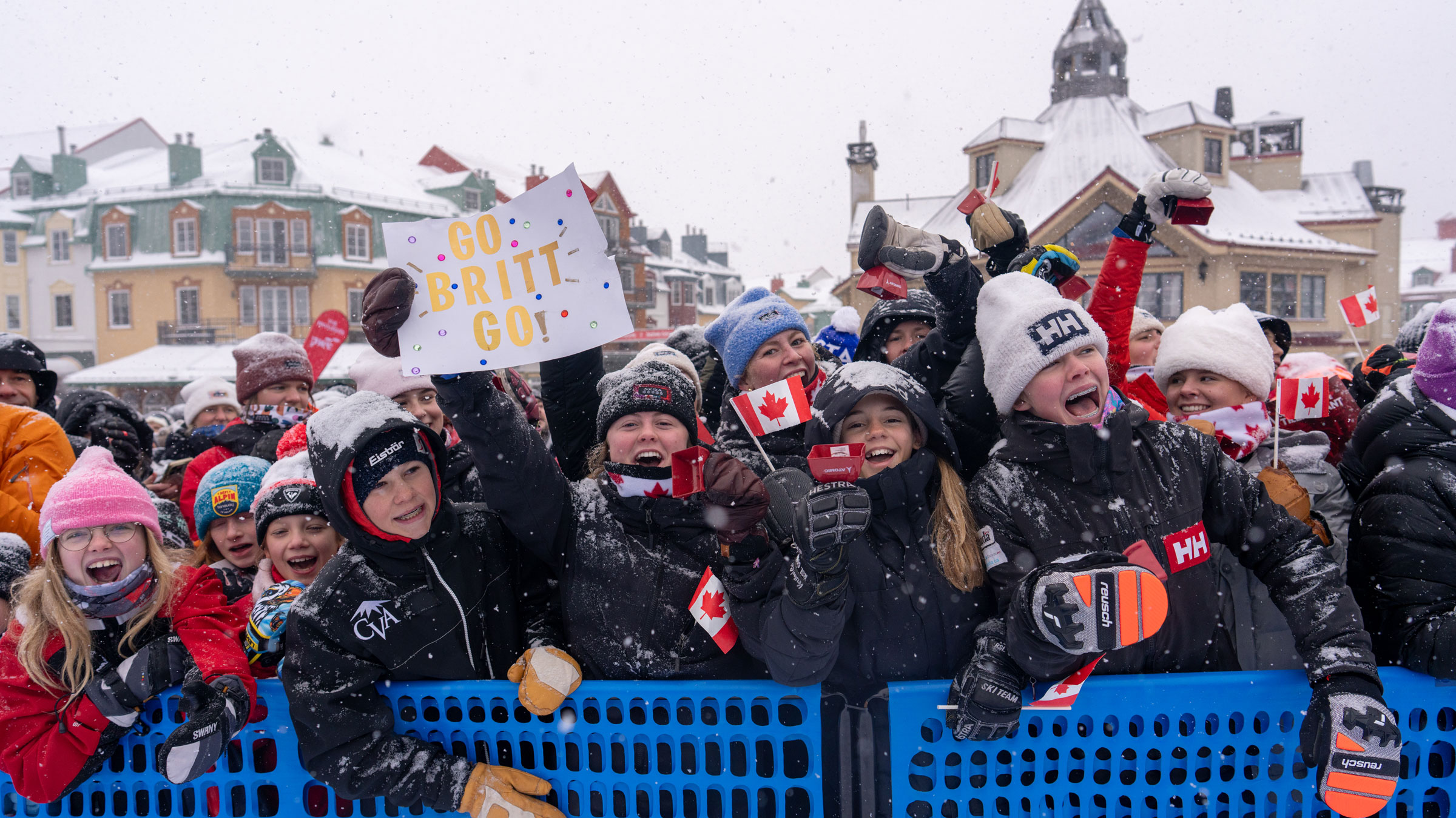 Enthusiastic crowd at Tremblant during the PwC World Cup, with snow and Canadian flags.